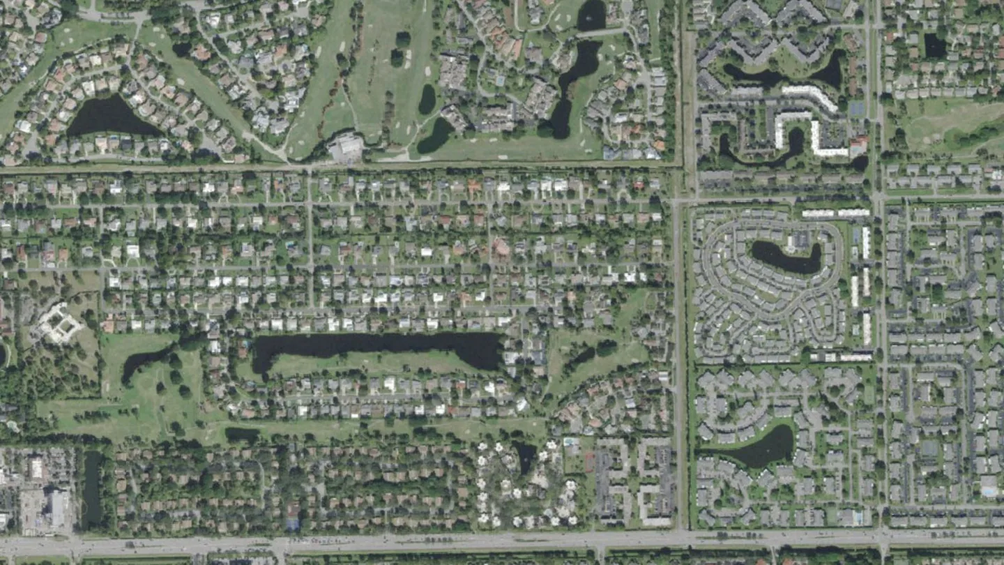 Aerial view of neighborhoods, lakes and a golf course in Delray Beach, septic tank pumping